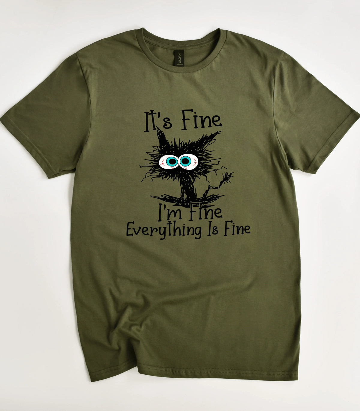Funny cat graphic tee with 'It's Fine I'm Fine' text on olive shirt