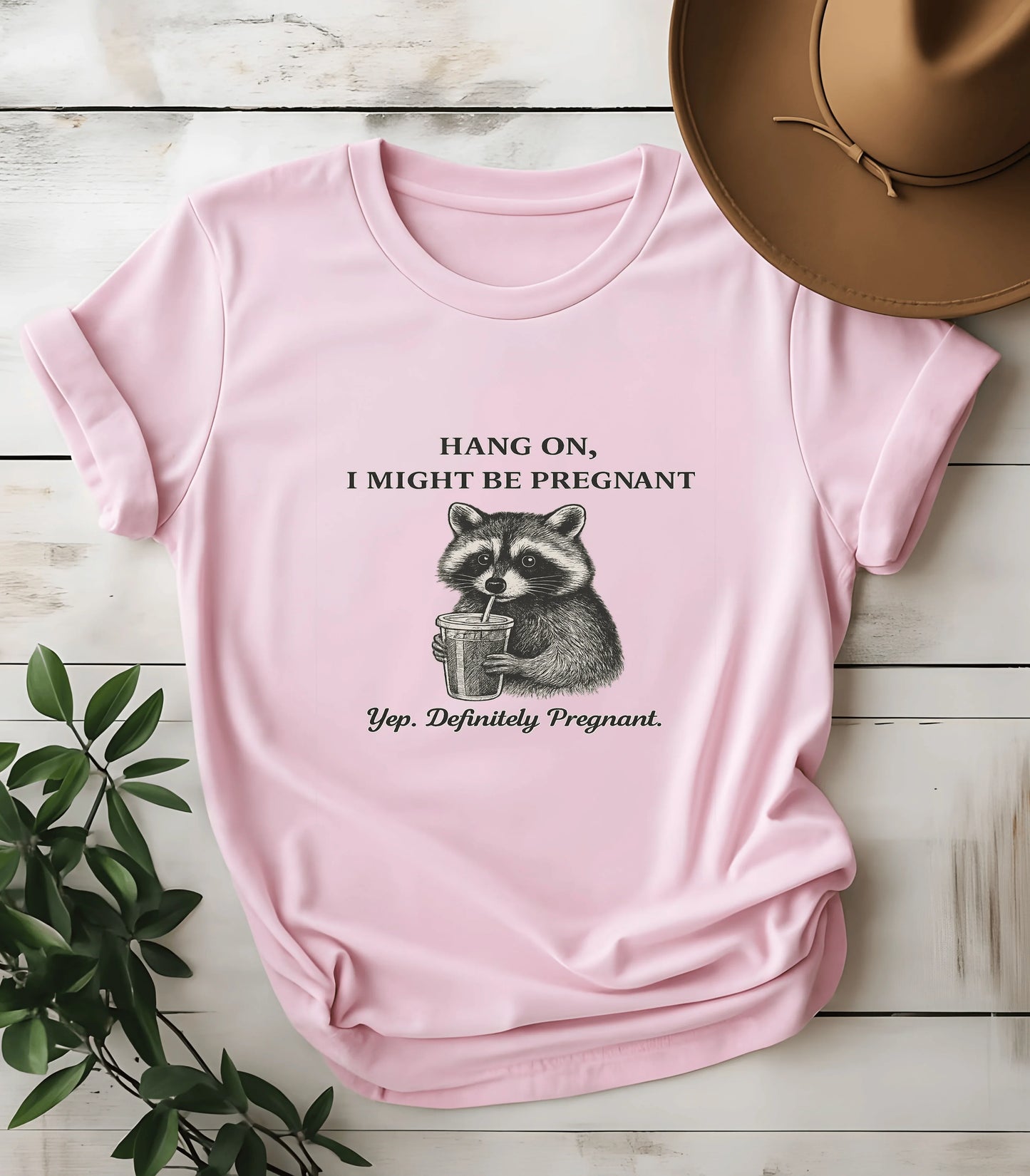 Funny raccoon graphic tee with pregnancy text on pink shirt