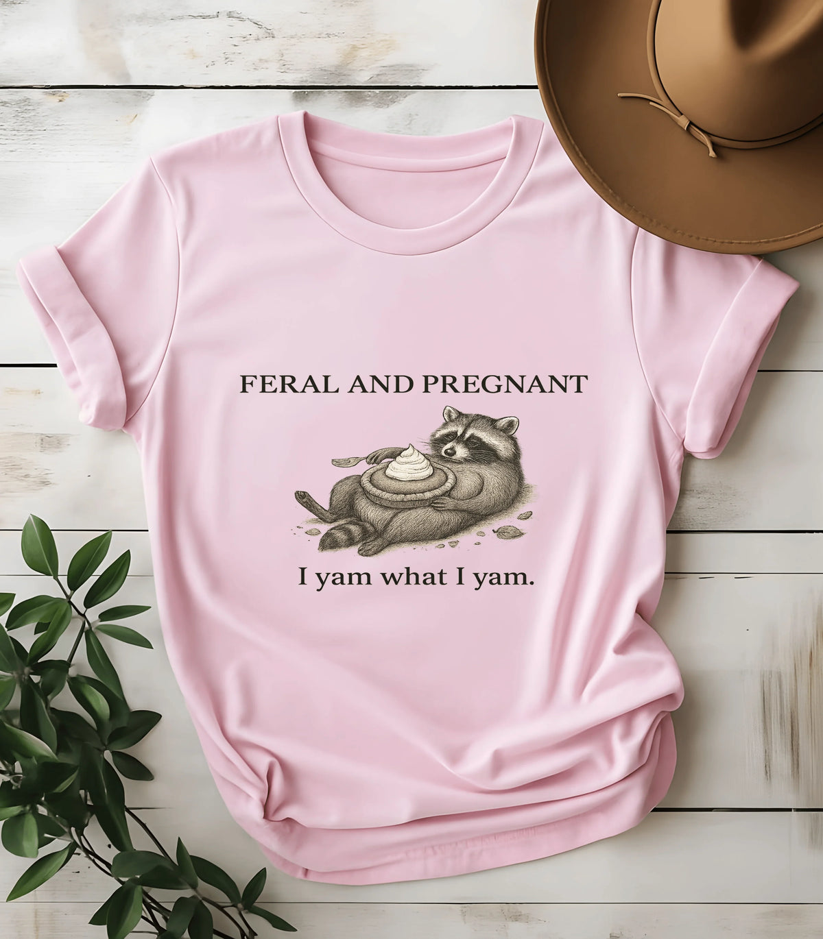 Feral and pregnant raccoon graphic tee on pink shirt