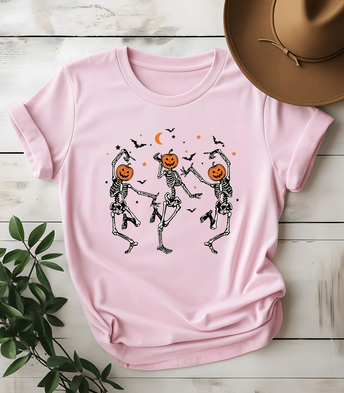 Pink t-shirt with dancing skeletons and pumpkin heads, Halloween graphic tee