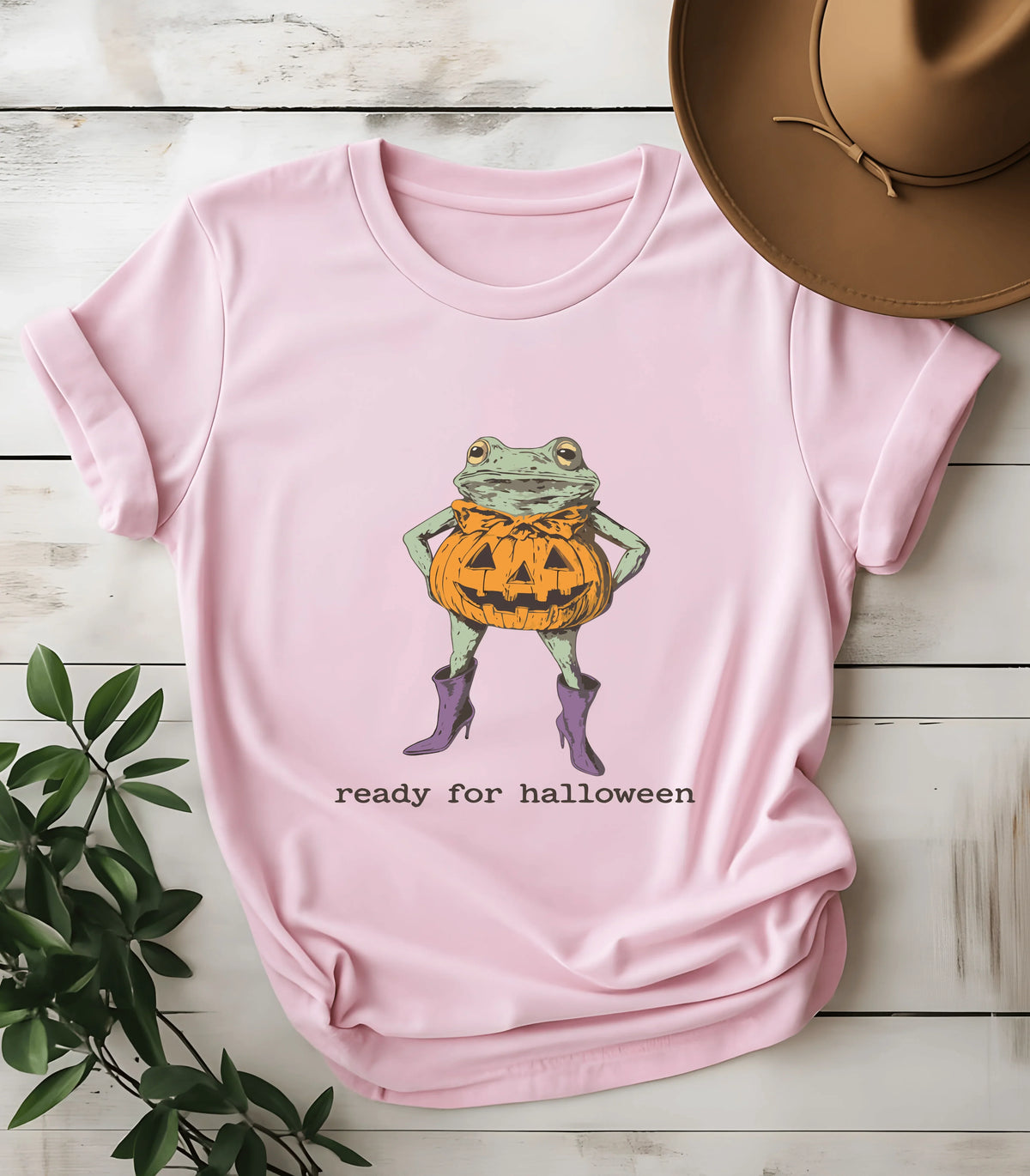 Funny frog in pumpkin costume graphic tee on pink shirt