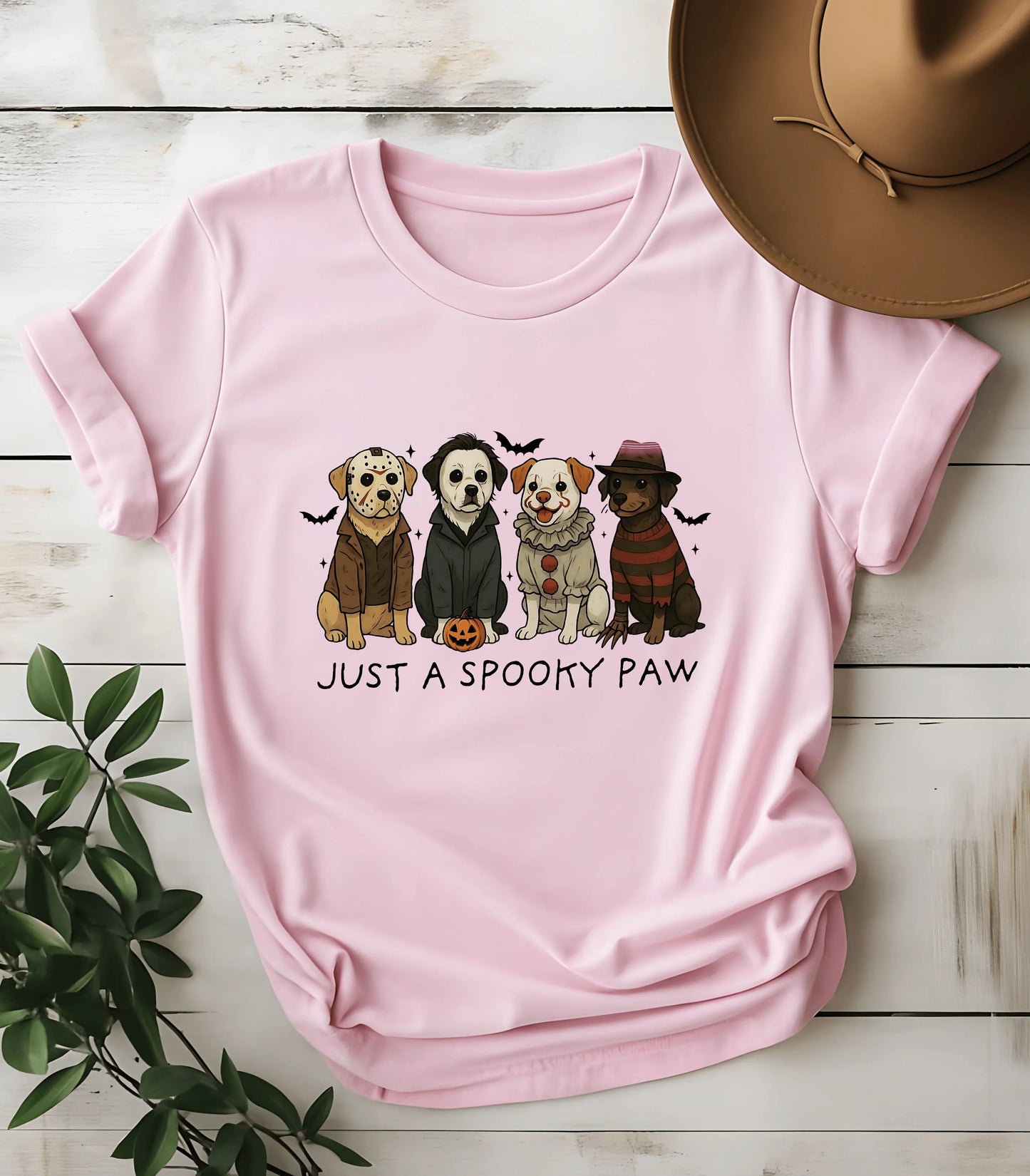 Spooky paw dog graphic tee with Halloween costumes on pink shirt