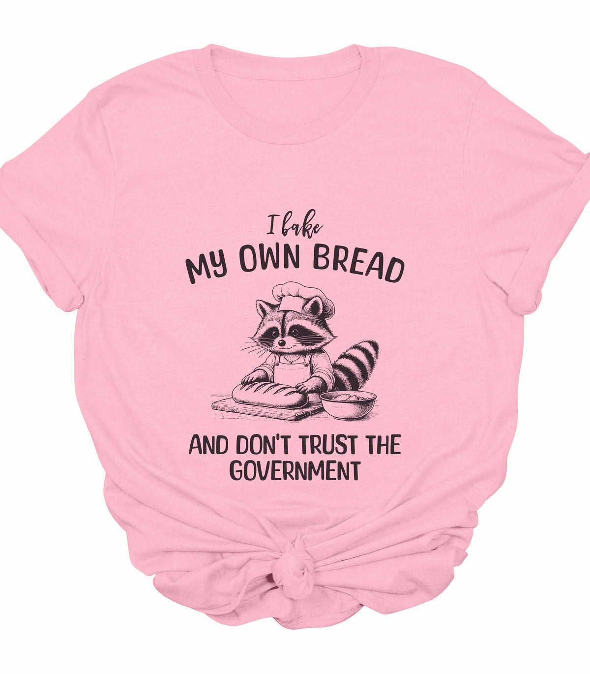 Funny raccoon baking bread graphic tee on pink shirt