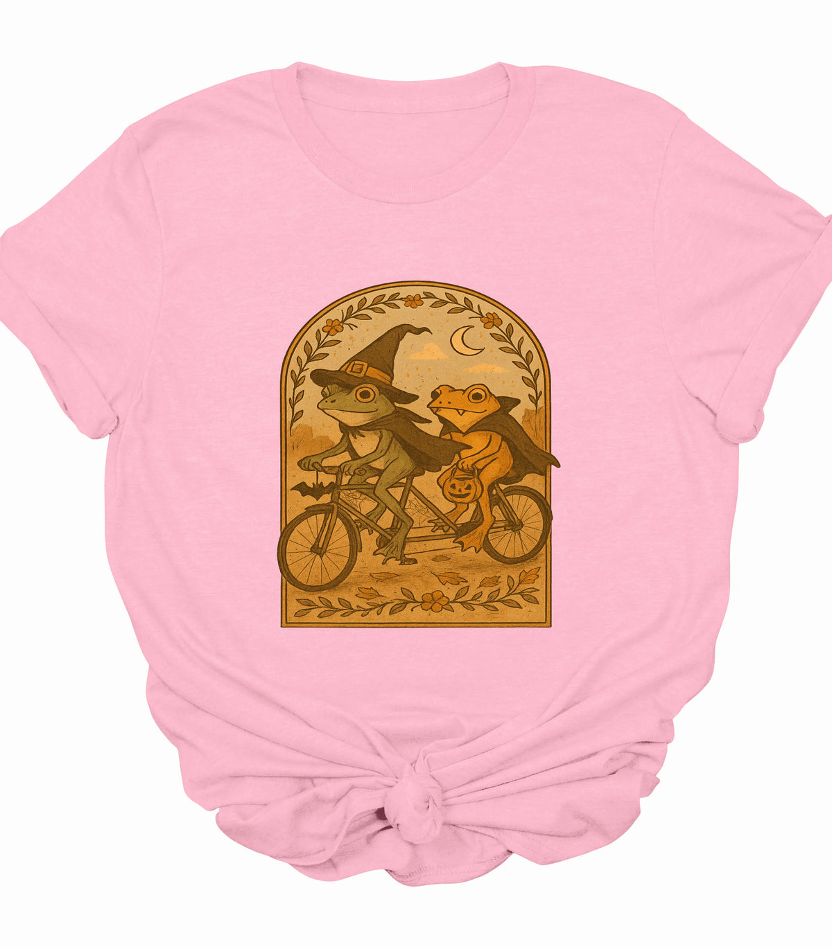 Funny frog witch and vampire riding tandem bike graphic tee on pink shirt