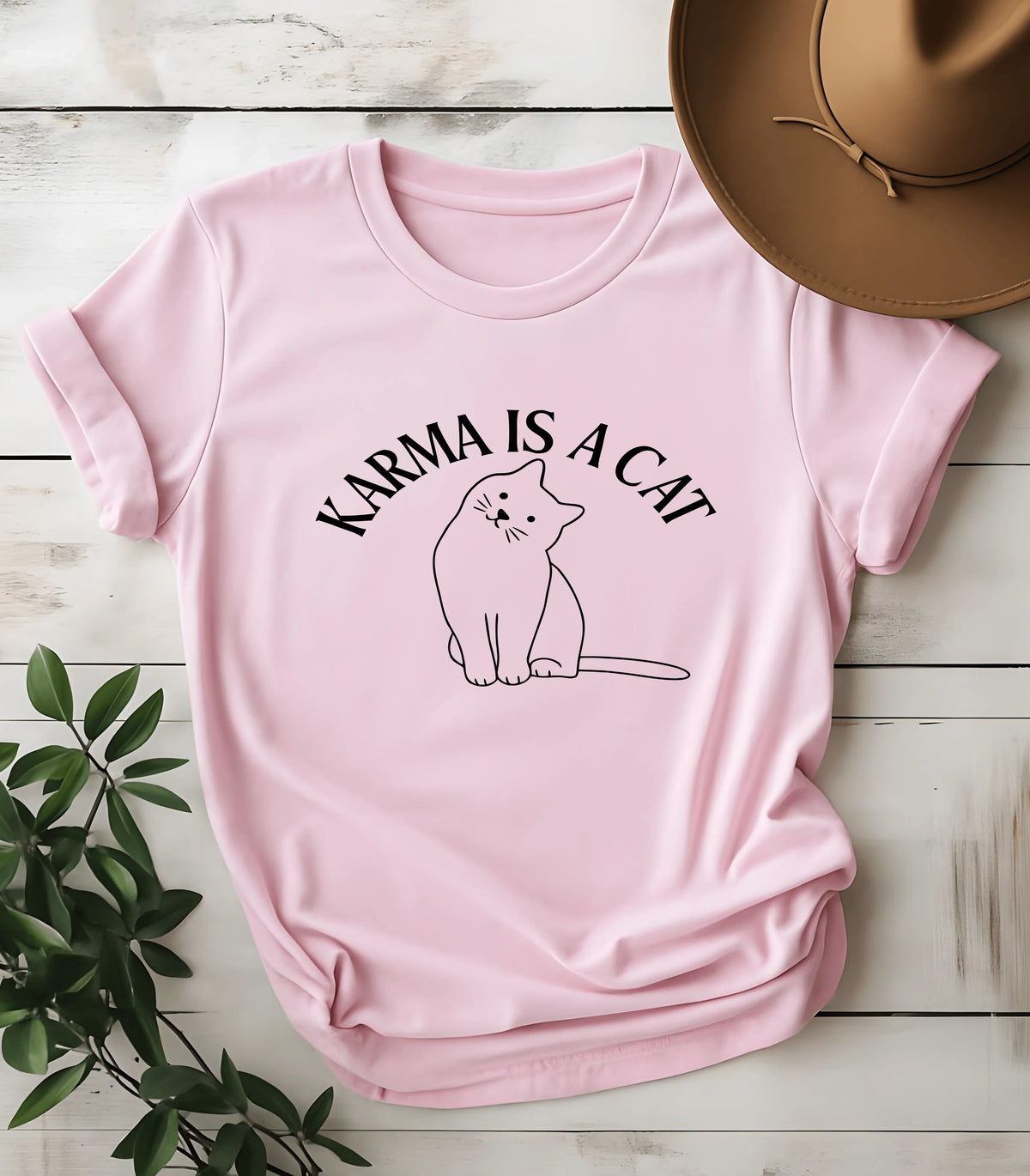 Pink t-shirt with 'Karma Is A Cat' text and cat graphic