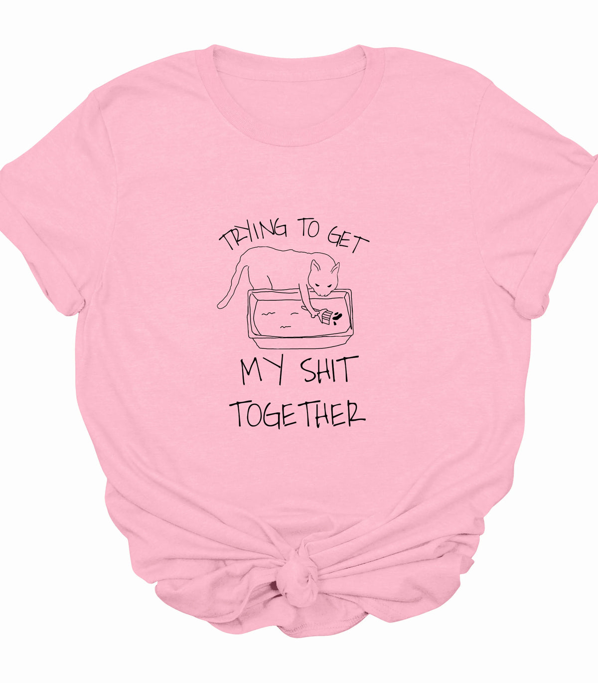 Funny cat graphic tee with 'Trying to get my shit together' text on pink shirt