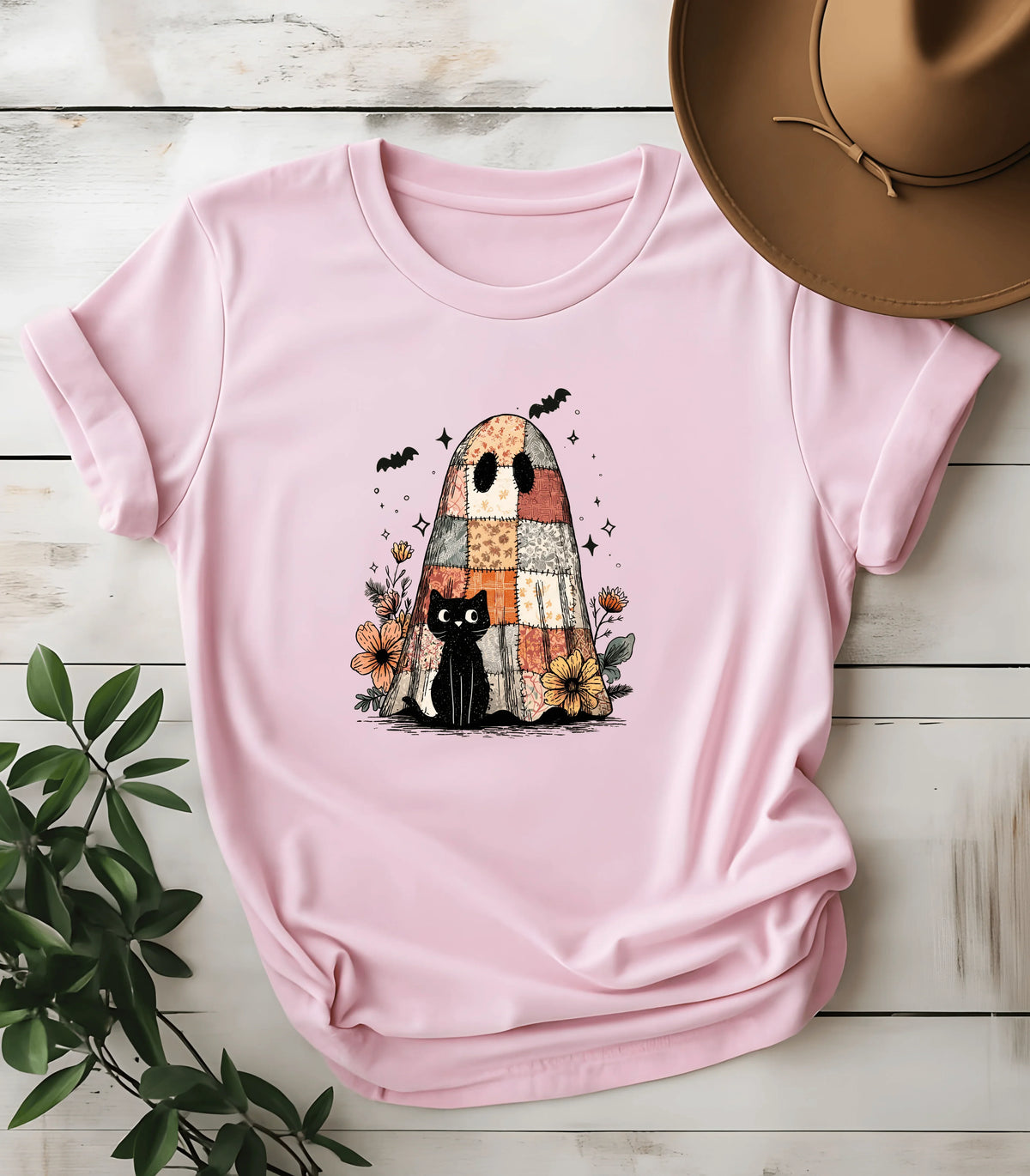 Pink t-shirt with black cat and patchwork ghost graphic, floral Halloween design