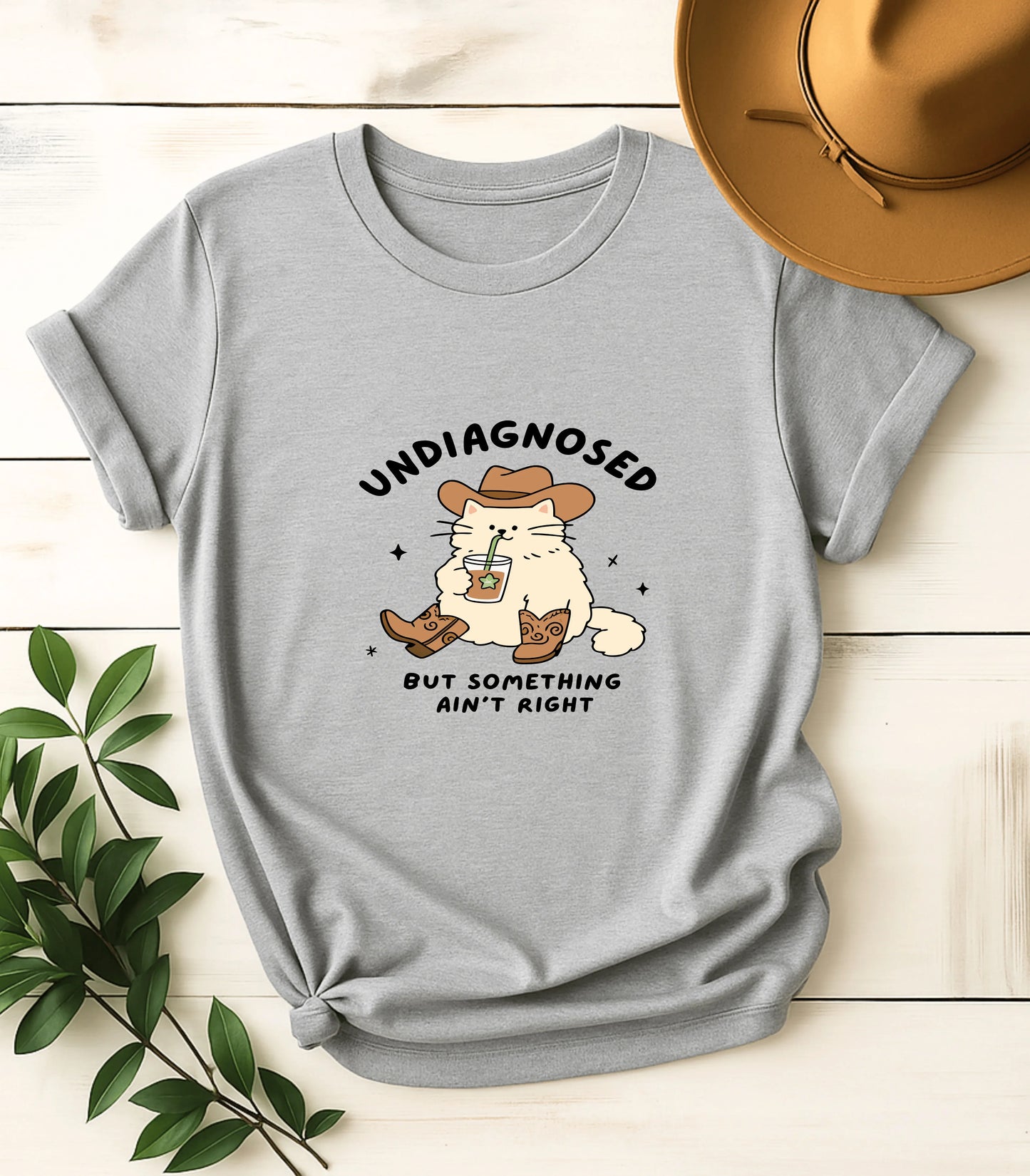 Funny cat graphic tee with cowboy hat and iced coffee, text 'Undiagnosed but something ain't right'