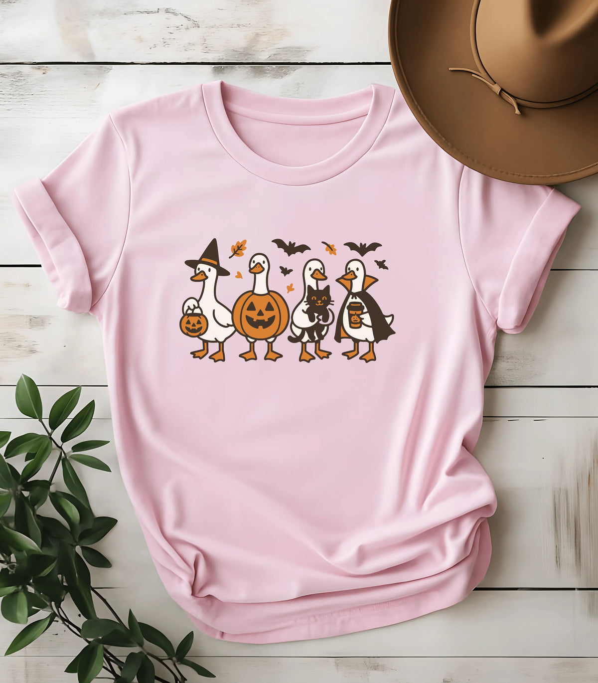 Halloween duck graphic tee with pumpkins and bats on pink shirt