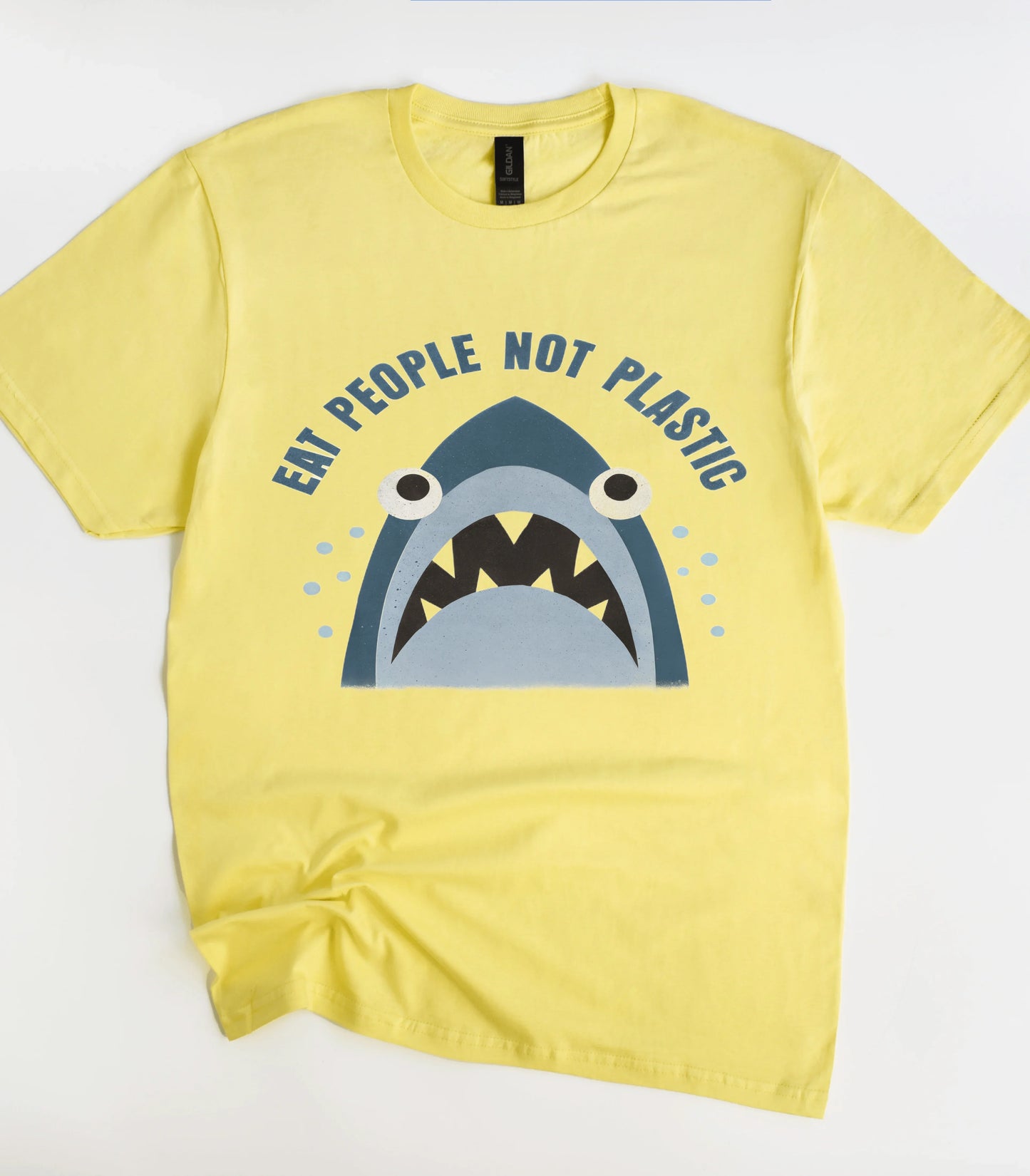 Yellow graphic t-shirt with shark design and 'Eat People Not Plastic' text