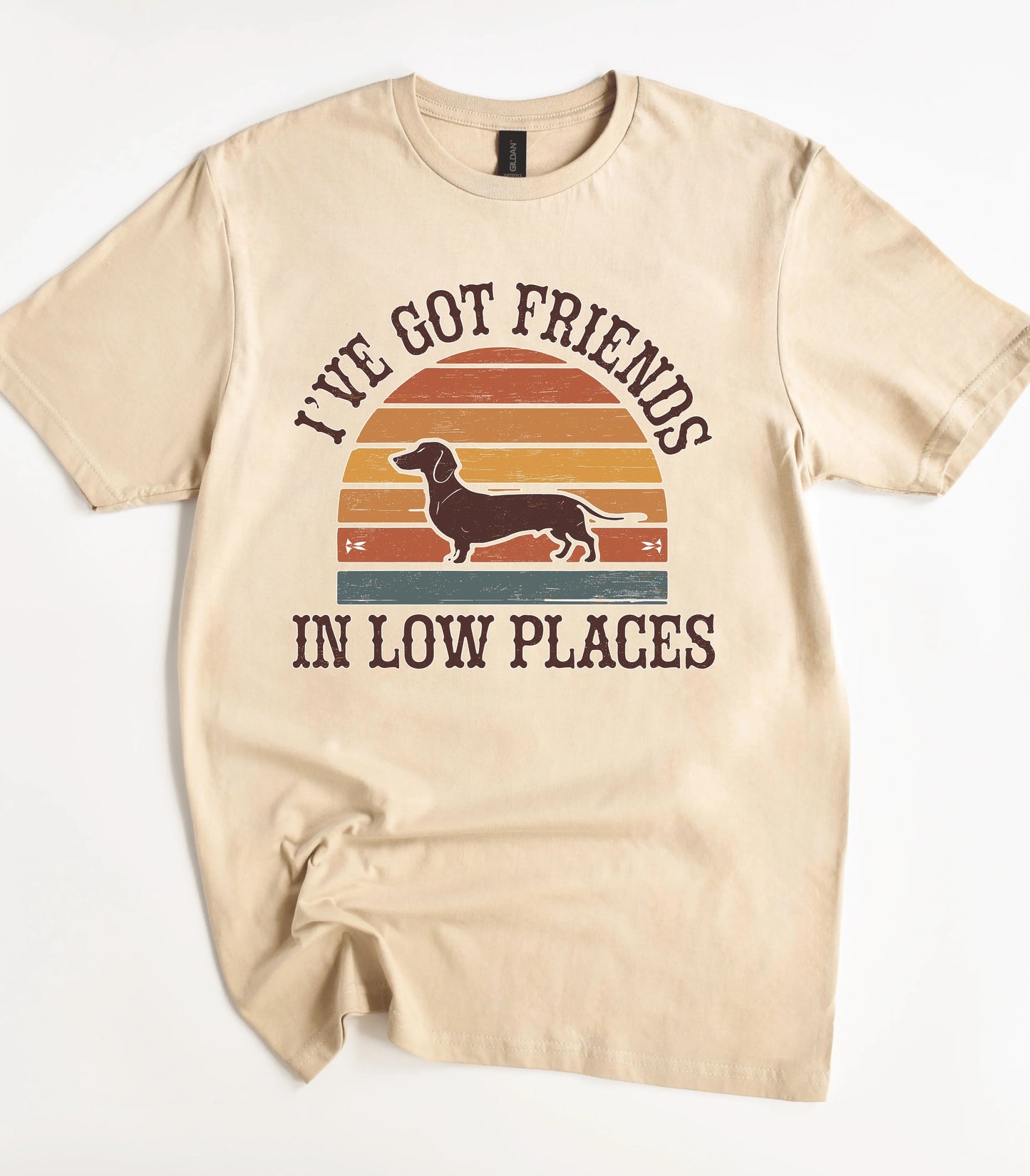Funny dachshund graphic tee with sunset design and text I've Got Friends In Low Places
