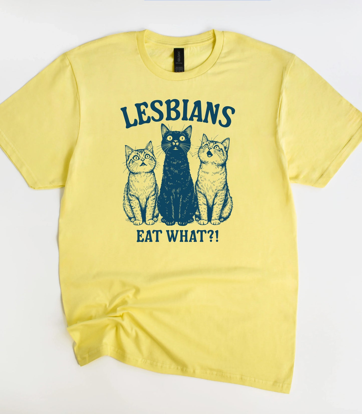 Yellow t-shirt with funny cat graphic and text 'LESBIANS EAT WHAT?!'