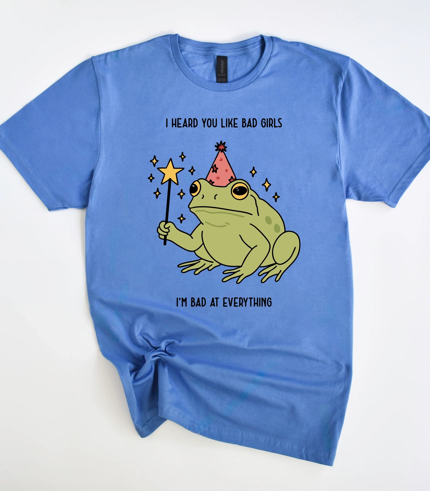 Funny frog graphic tee with party hat and wand on blue shirt