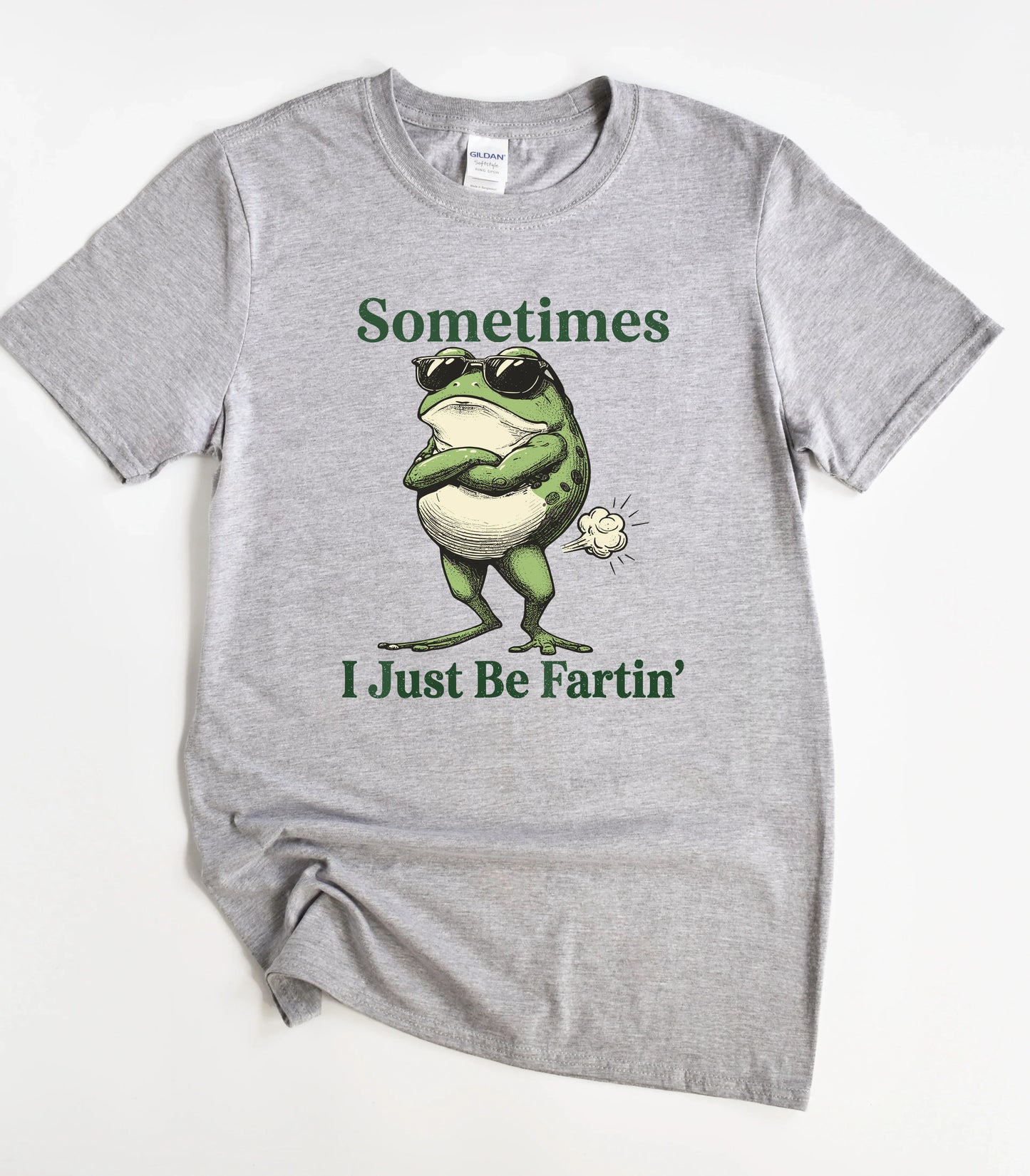Funny frog graphic tee with sunglasses and farting design