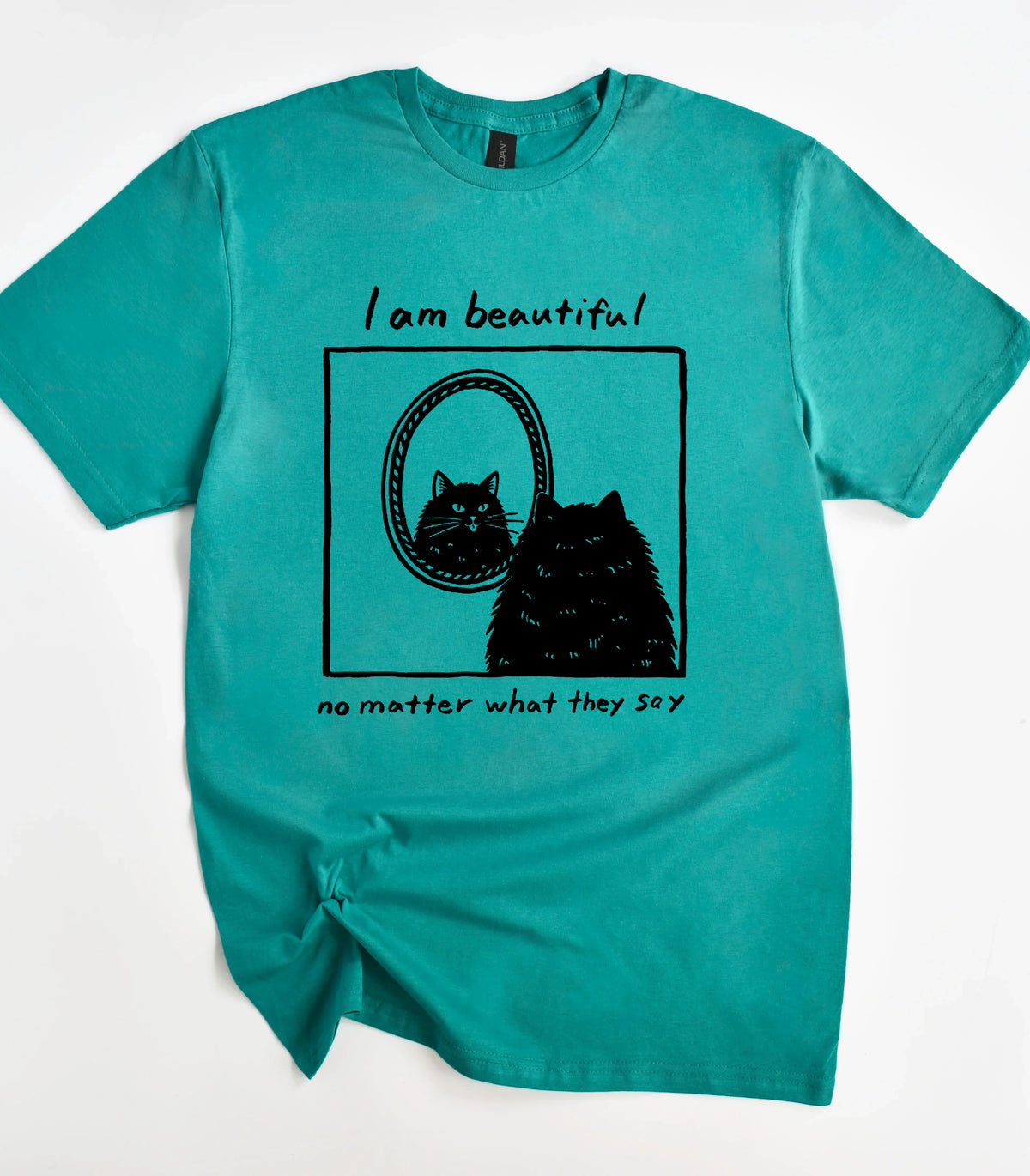 Funny cat graphic tee with 'I am beautiful' text on teal shirt