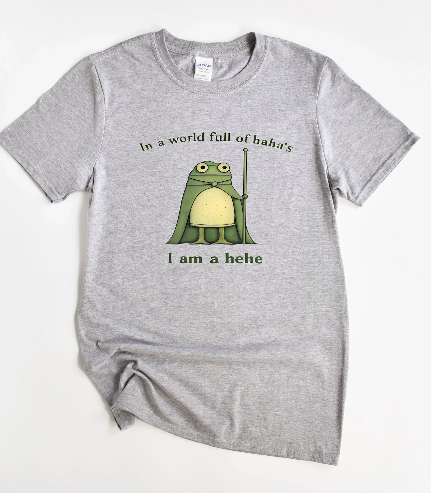 Funny frog graphic t-shirt with 'I am a hehe' text on gray tee