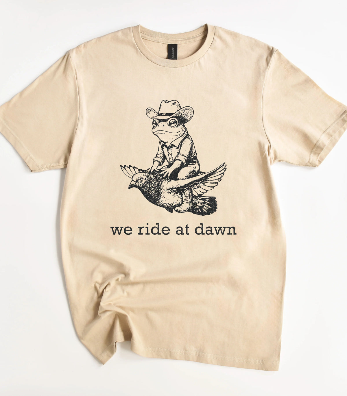 Funny frog cowboy riding bird graphic tee with we ride at dawn text