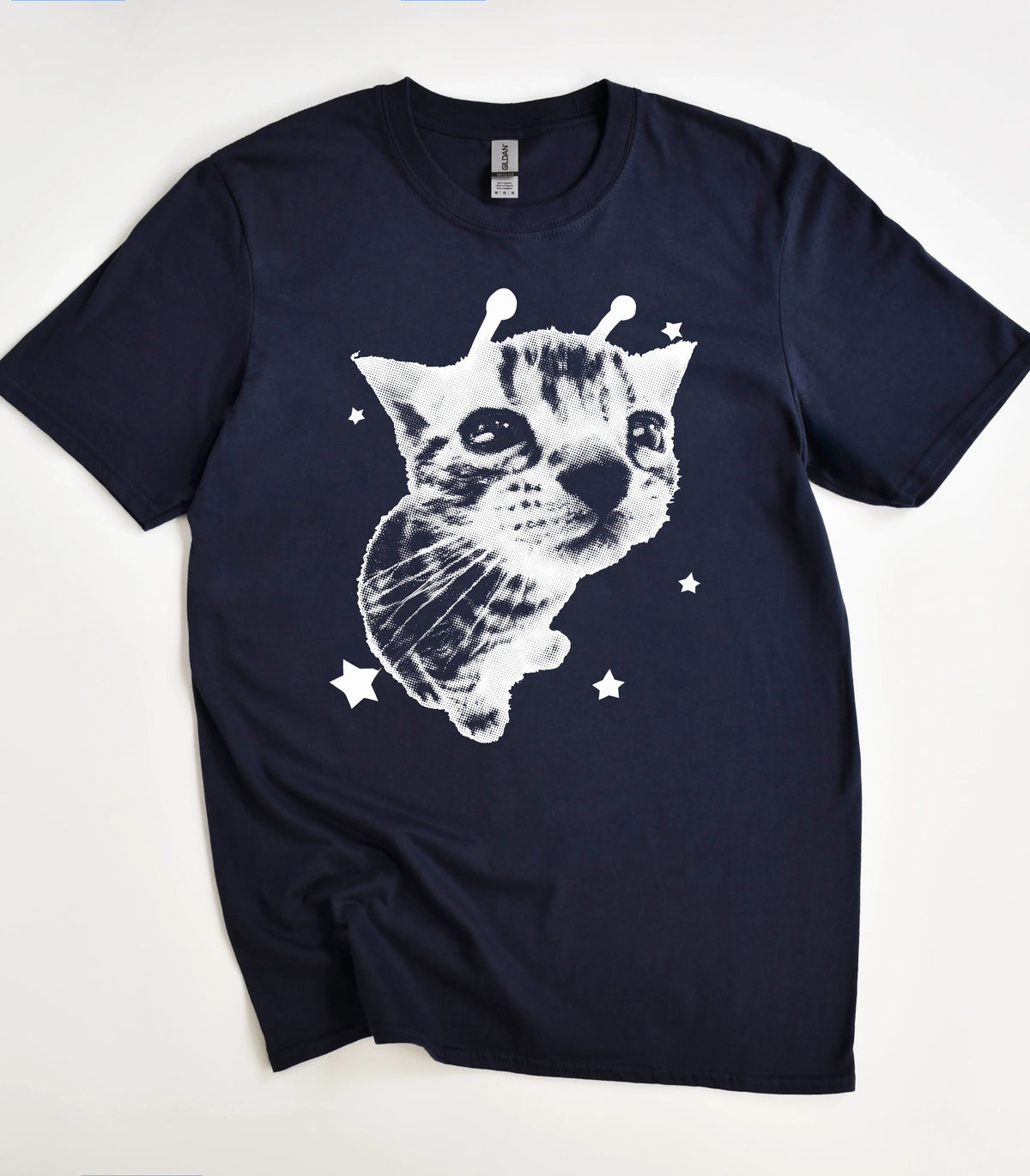 Funny cat graphic tee with star accents on navy shirt
