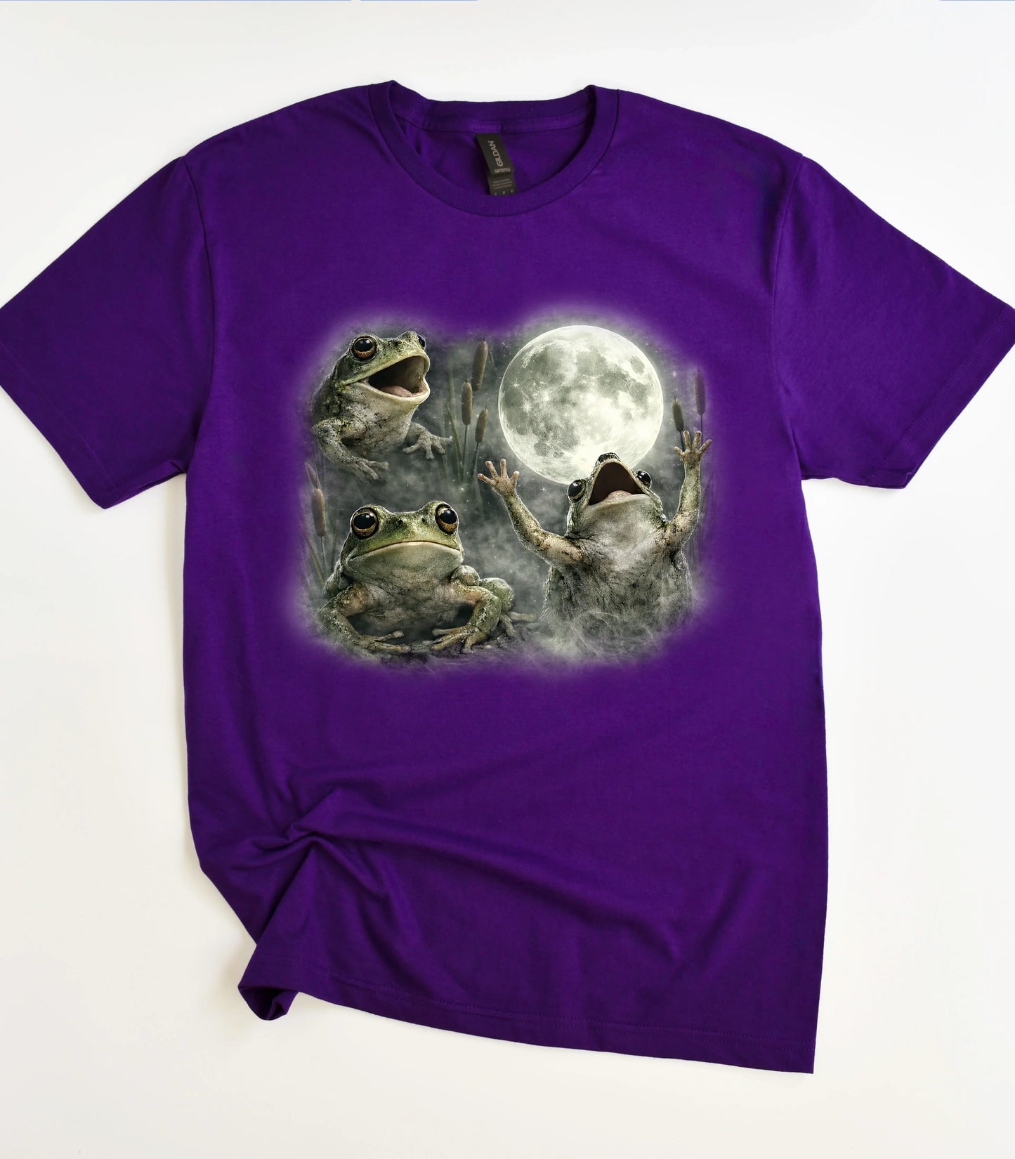Purple graphic t-shirt with three frogs and a full moon design