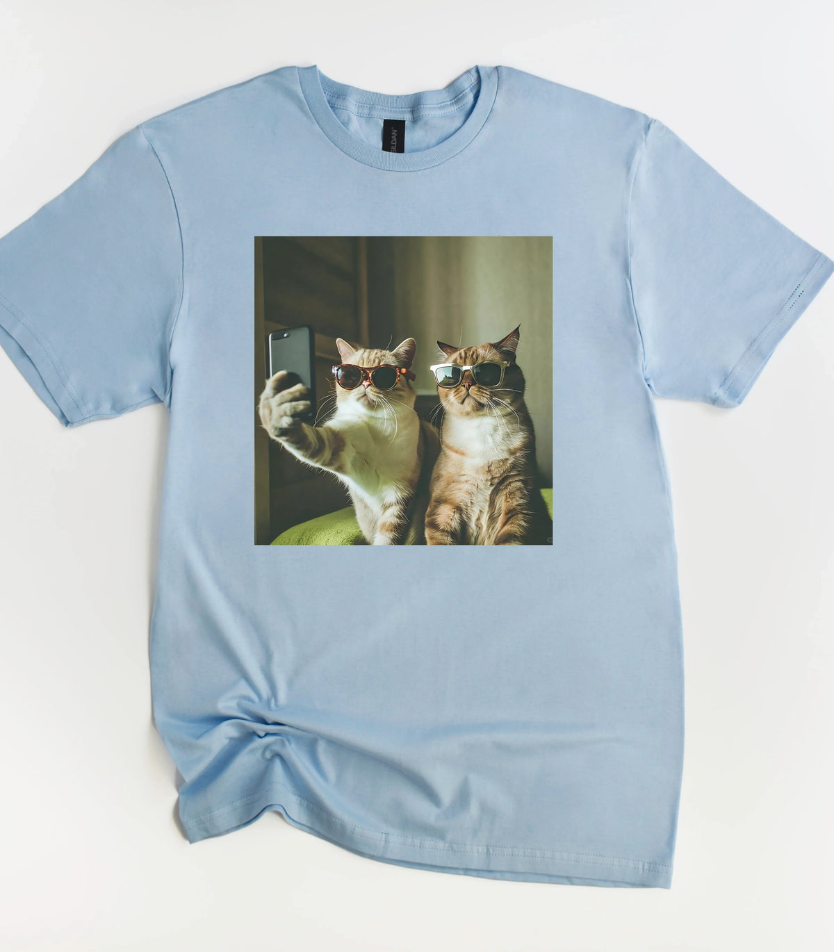 Two cats in sunglasses taking a selfie on light blue t-shirt