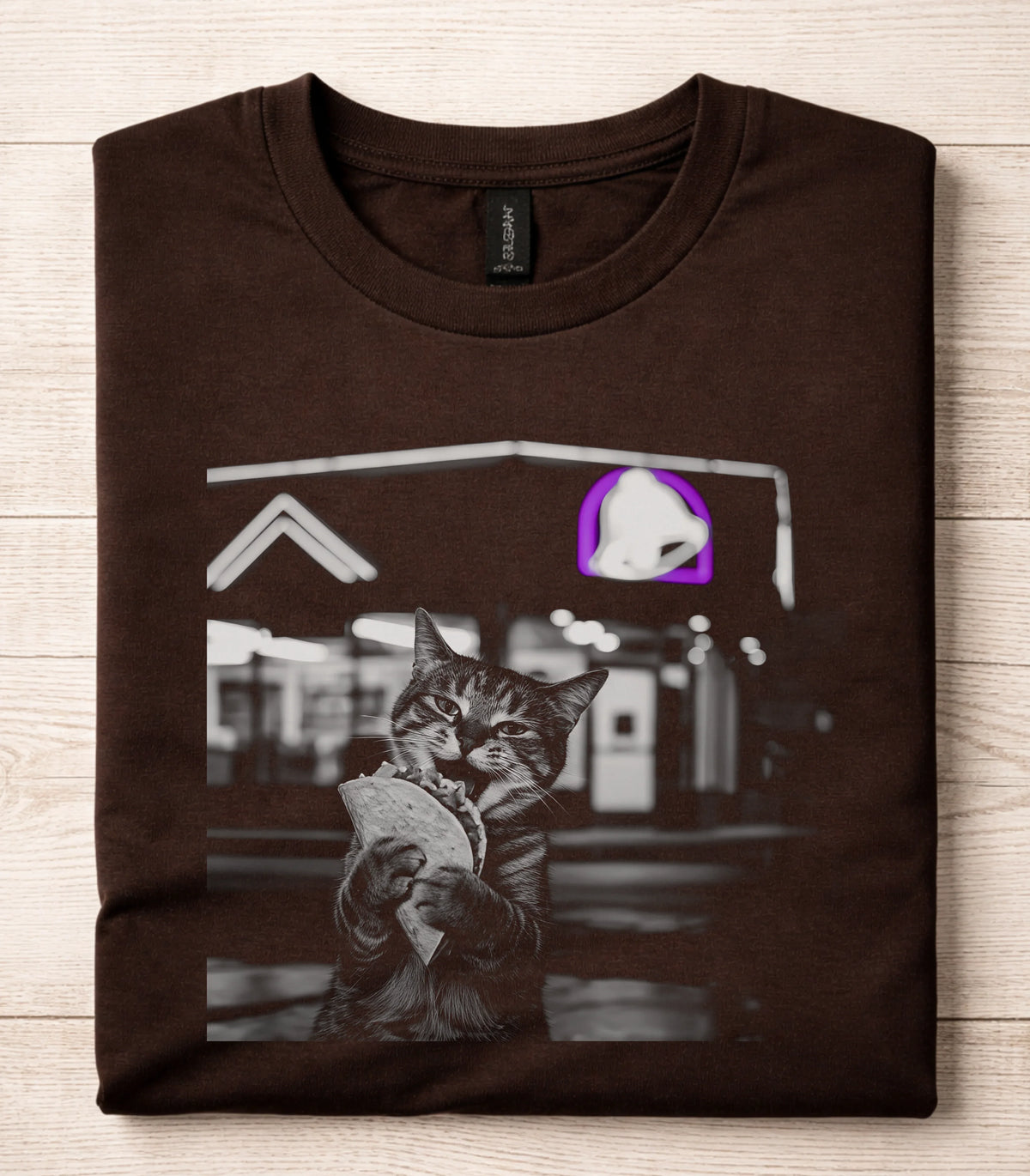 Funny cat graphic tee with taco-eating cat design on brown shirt